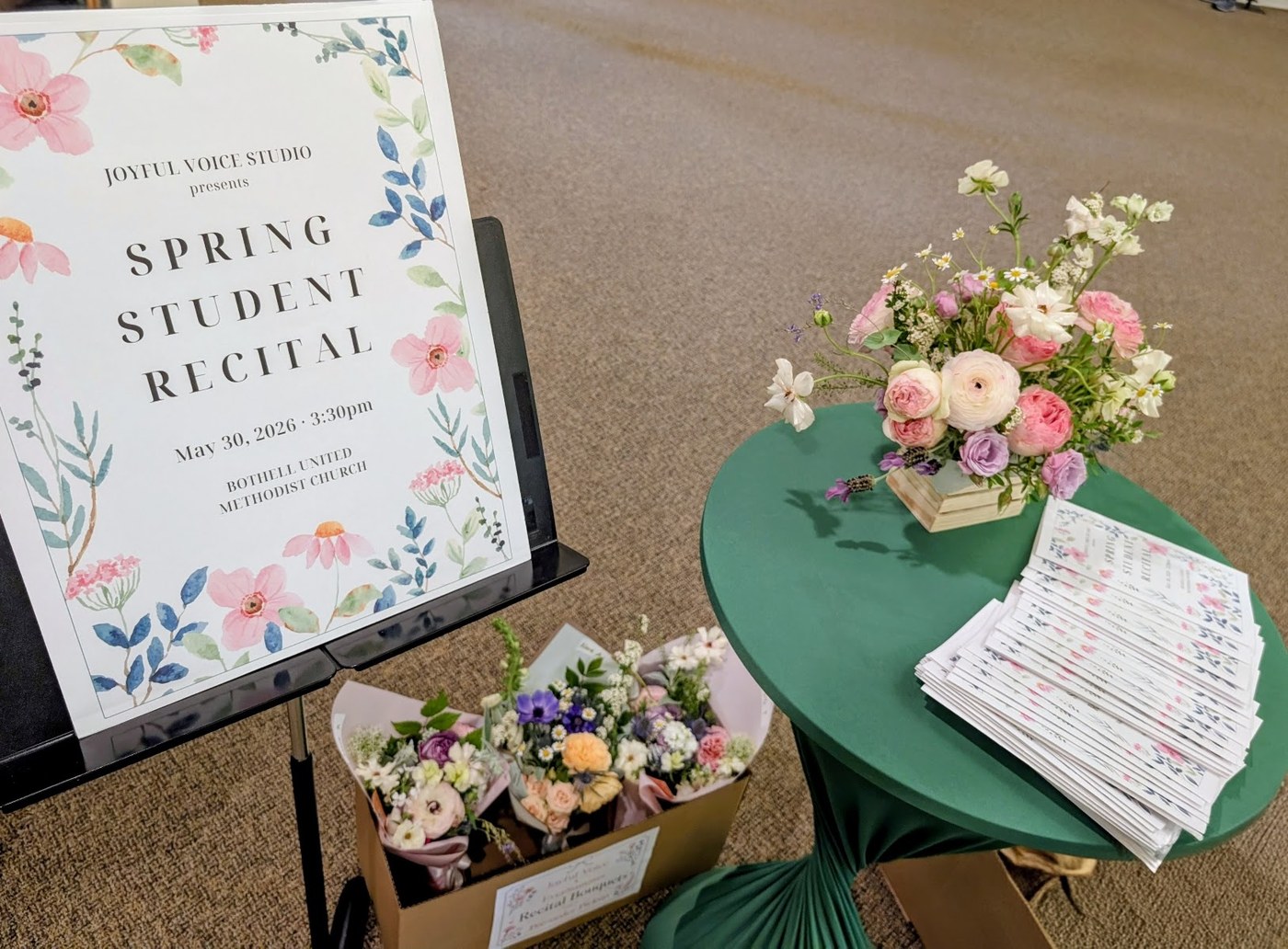 Joyful Voice Studio Spring Student Recital, May 30 2026, at Bothell United Methodist Church, with a box of pre-ordered bouquets and a romantic table arrangement