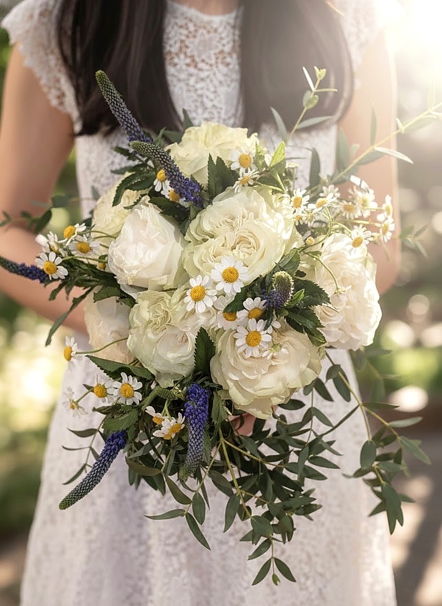 Bridal bouquet — white garden roses, chamomile, veronica, and trailing greens